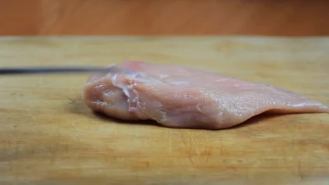 Chef opens the chicken breast Video stock 103417678