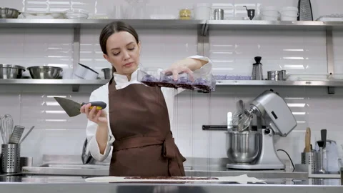 Chef or chocolatier makes sweet chocolates in a professional kitchen. Stock Footage 170103981
