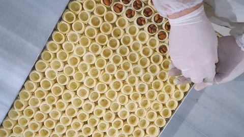 The chef of oriental sweets adds almonds to the dough to make Osh Stock Footage 255102794