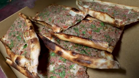 Chef Packaging Traditional Turkish Pide (Flatbread) with Meat Topping into a Box Stock Footage 323183136