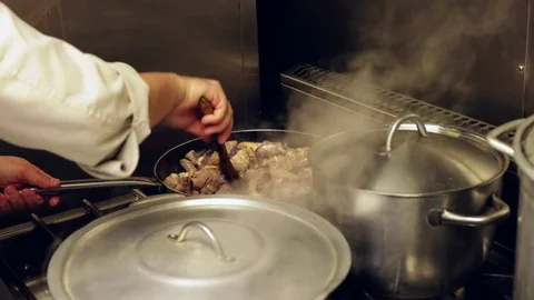 Chef with pan in flames Stock Footage 72976405