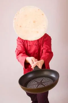 Chef with pan turning pancake Stock Photos