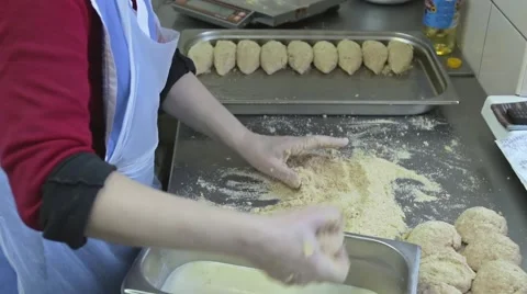 Chef paneers cutlets in breadcrumbs and puts them on a dripping pan Stock Footage 58854206