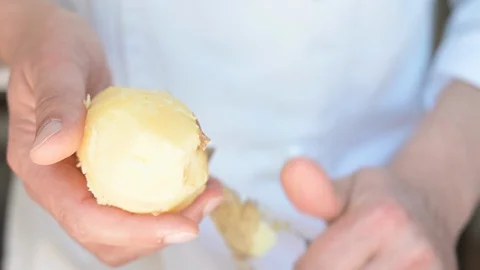 Chef peeling boiled potatoes 스톡 동영상 128310290