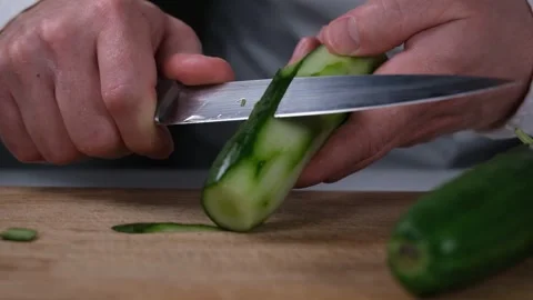 Chef peeling cucumber Stock Footage 240134065