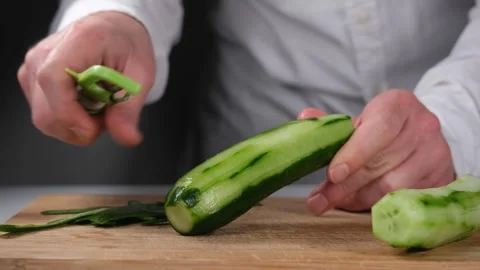 Chef peeling cucumber Stock Footage 240134726