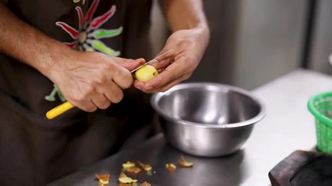 Chef Peeling Fresh Potato with Paring Knife in Commercial Kitchen Stock Footage 345713128