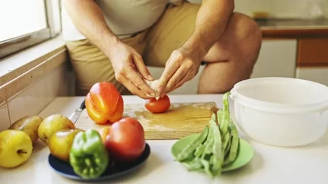 Chef peeling garlic clove for vegetable preparation Stock Footage 307966623