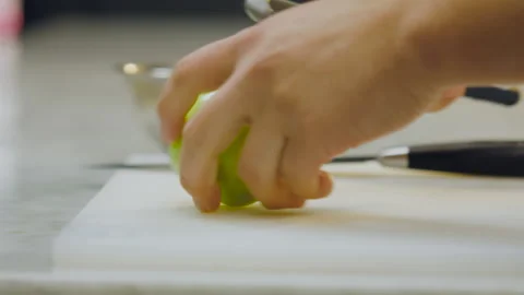 Chef peeling a green apple on a board in close-up. Stock Footage 321385410
