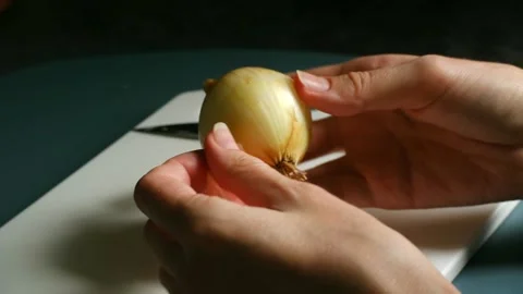 Chef peeling onion on cutting board Stock-Footage 311944284