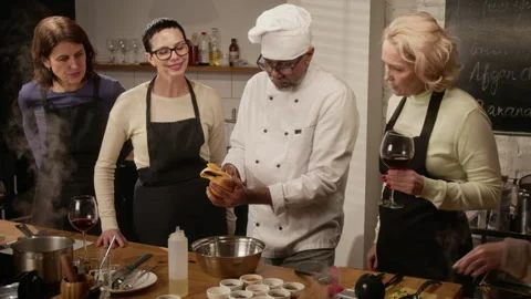 Chef Peeling Orange at Cooking Master Class in Restaurant Stock Footage 332574088