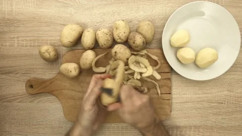 Chef peeling potato with knife Stock Footage 121977621