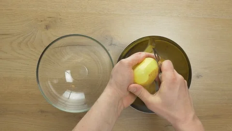 Chef peeling potatoes and grating them Stockbeeldmateriaal 105220458