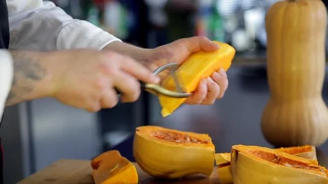 Chef is peeling a pumpkin. Stock Footage 88943195