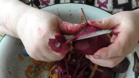 The chef peels a beet with a knife Stock Footage 163050774