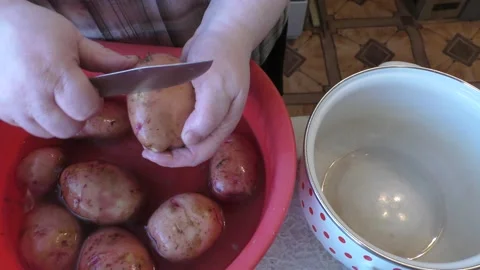 The chef peels a potato with a knife Stock Footage 165612581