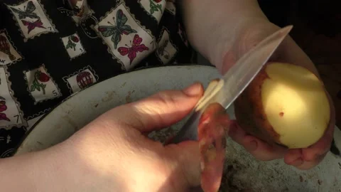 The chef peels a potato with a knife Stock Footage 166707918