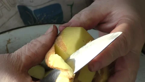 The chef peels the potatoes with a knife Stock Footage 164357354