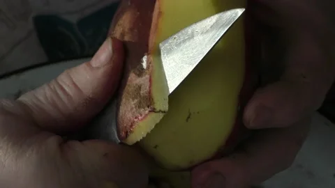 The chef peels the potatoes with a knife Stock Footage 164358219