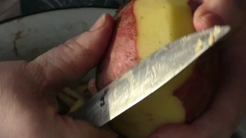 The chef peels the potatoes with a knife Stock Footage 164358472