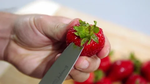 Chef peels the Strawberry Stock Footage 221698680
