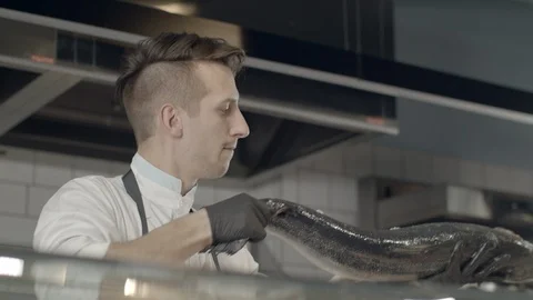 Chef Picking Fresh Salmon From Ice Display At The Seafood Restaurant Next To Video stock 113396553