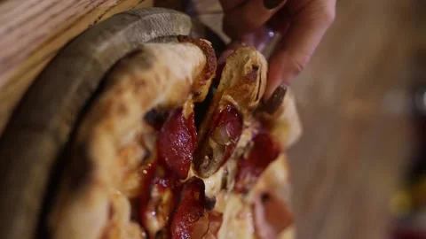 Chef picking up a slice of pizza. Pizzaiolo taking a slice of ready-made pizza Stock Footage 233939444