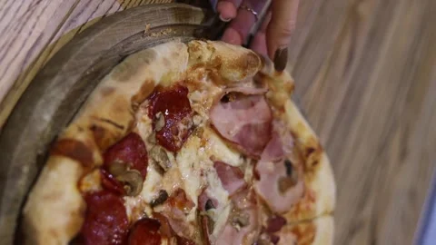 Chef picking up a slice of pizza. Pizzaiolo taking a slice of ready-made pizza Stock Footage 233939457