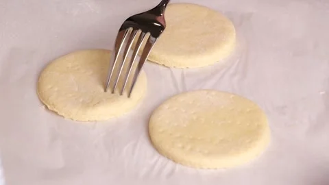Chef piercing raw dough with fork in slow motion Stock Footage 305878241