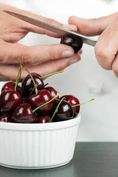 Chef pitting cherry Stock Photos