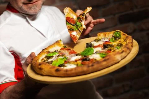 Chef with pizza slice Stock Photos