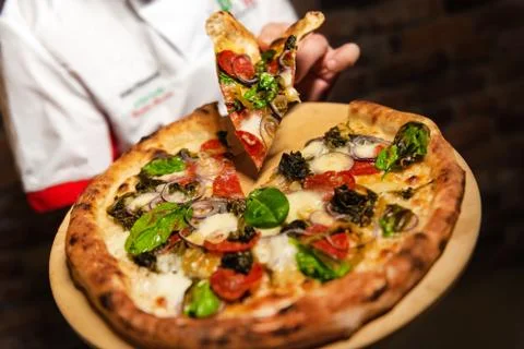 Chef with pizza slice Foto stock