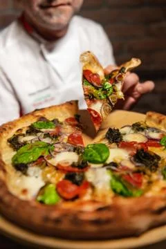 Chef with pizza slice Stock Photos