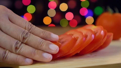 Chef place a tomato slice on cutting board in light bokeh background Stock Footage 92083728
