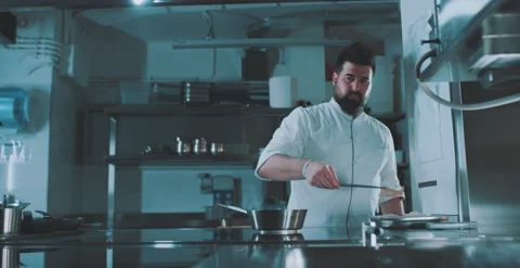 Chef places ingredient into pot Stock Footage 204973421