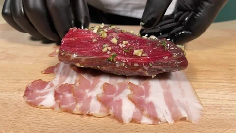 The chef places meat on bacon Stock Footage 306803731