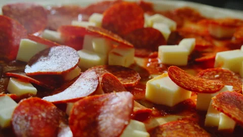 Chef places thin slices of salami across surface of pizza Stock Footage 326371332