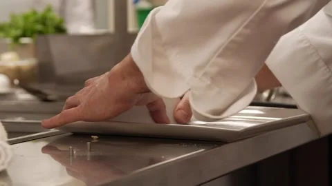 Chef placing brown sticky rice in a white plate Stock Footage 307339979