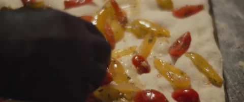 Chef placing colorful cherry tomatoes on a fresh pizza dough. Slow motion, cl Stock Footage 147518173