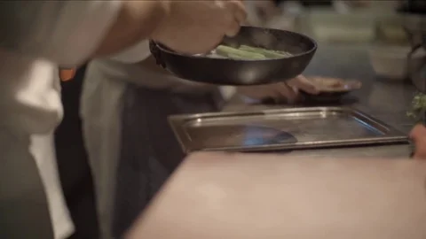 Chef placing cooked asparagus on the tray Stock Footage 72981394