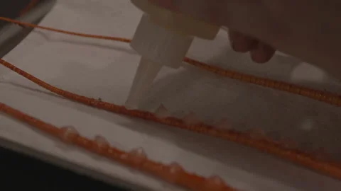 Chef placing cream hazelnuts on stems Видео 335703106