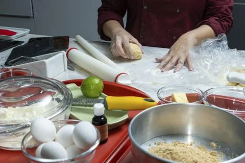 Chef placing the dough to be stretched on the rolling pin. Stock Photos