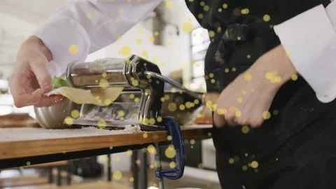 Chef placing dough clamping roller turning crank guiding sheet for thin pasta Stock Footage 333485811