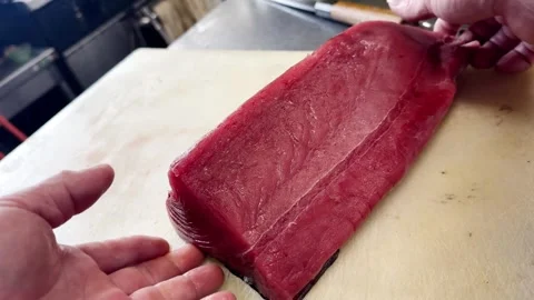 Chef Placing a Fresh Lean Tuna Loin Block on a Cutting Board, Japan Stock Footage 340333163