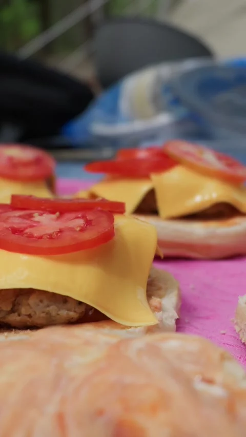Chef Placing Fresh Tomato Slices on a Gourmet Cheeseburger Close Up Stock Footage 342001323