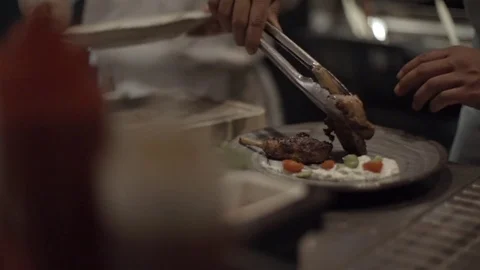 Chef placing the grilled meat chops in the plate in slow motion Stock Footage 72981254