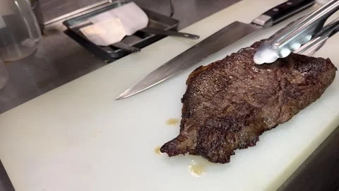 Chef Placing Grilled Wagyu Beef Steak On Cutting Board With Tongs Japan 4K Stock Footage 342411128