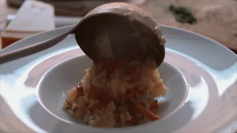 Chef placing Italian mushroom risotto (risotto ai funghi) in a dish Stock Footage 251995672