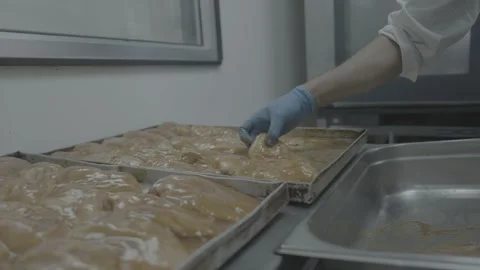 Chef placing marinated chicken into a tray 스톡 동영상 327353335