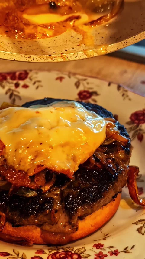 Chef placing melted cheese on gourmet beef burger patty with caramelized on.. Stock Footage 337477861